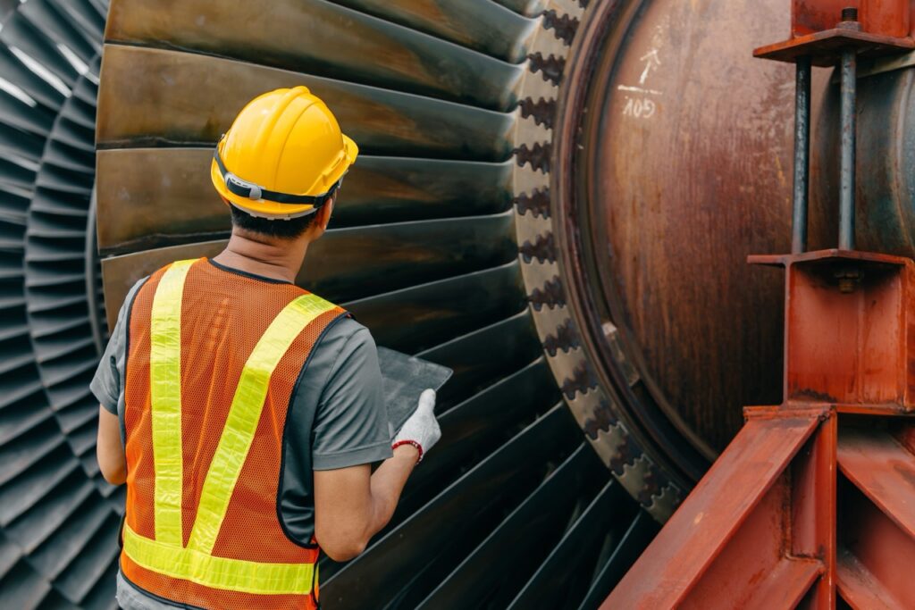 Professional engineer male working checking service coal power plant steam gas turbine fan blade electrical generator propulsion systems.